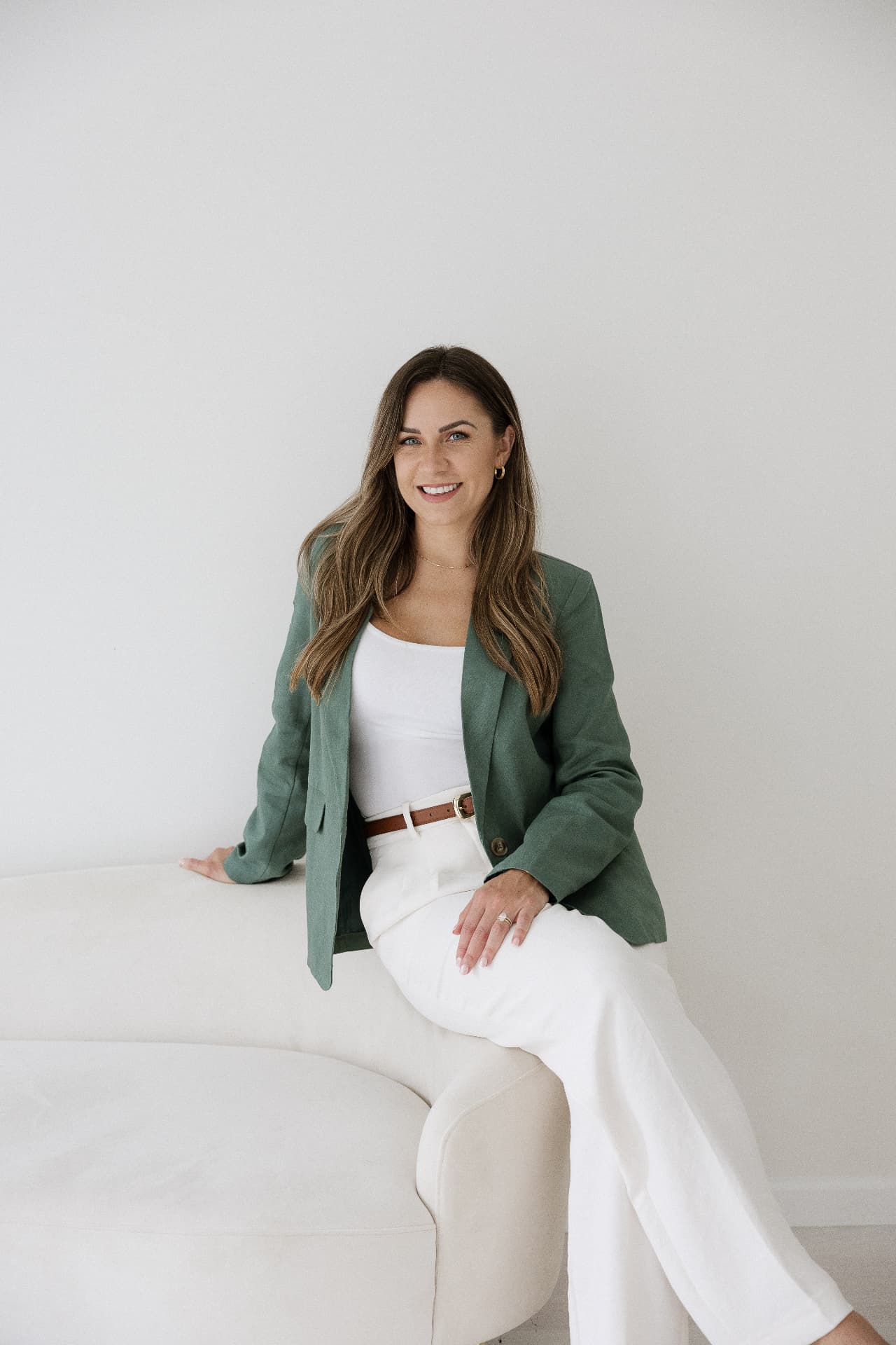 Alyssa Roberge Cook, RN, BSN, BC-FMP, seated in a green blazer